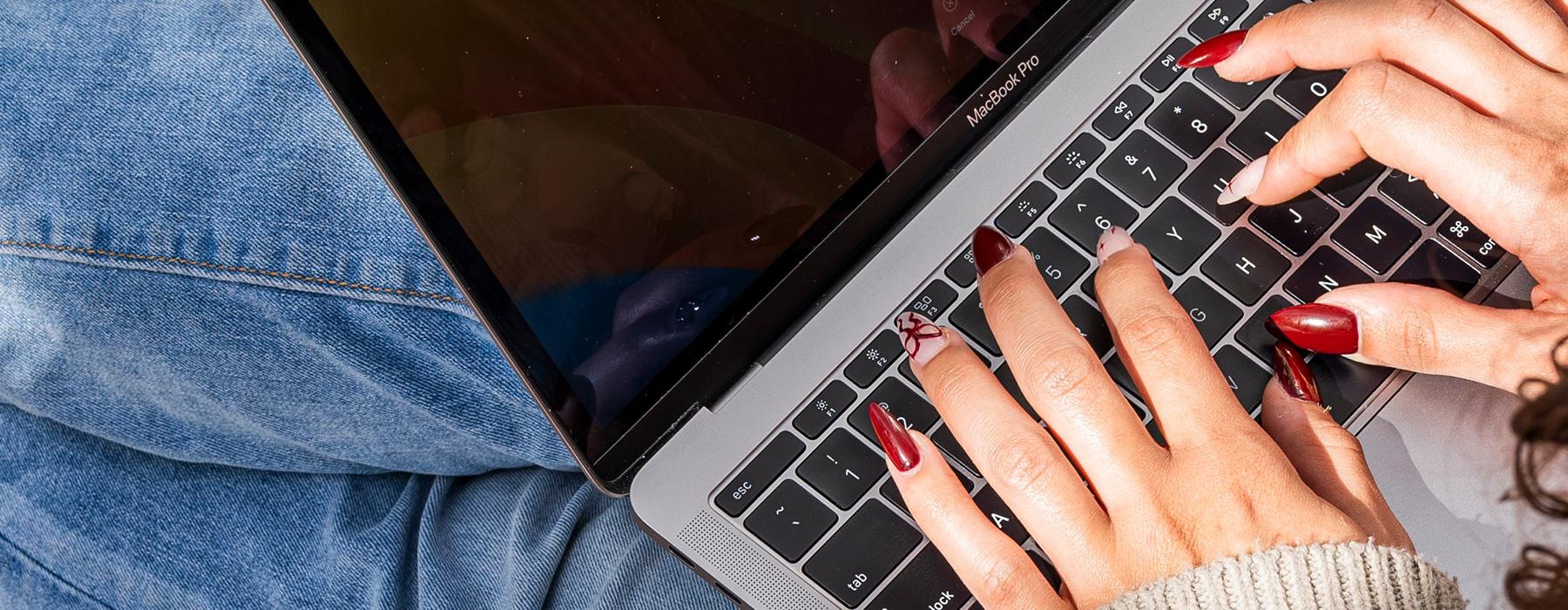 hands on a laptop