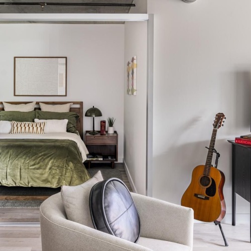 Gorgeous living areas to entertain and enjoy a bedroom with a bed and a chair
