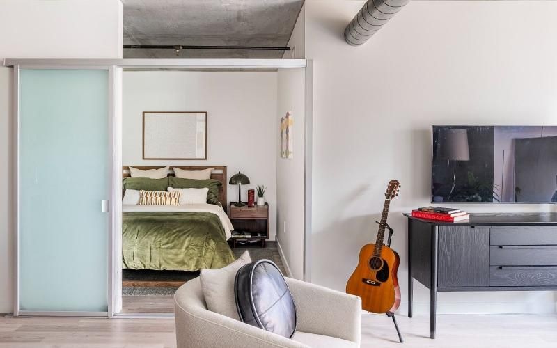 a bedroom with a bed and a chair