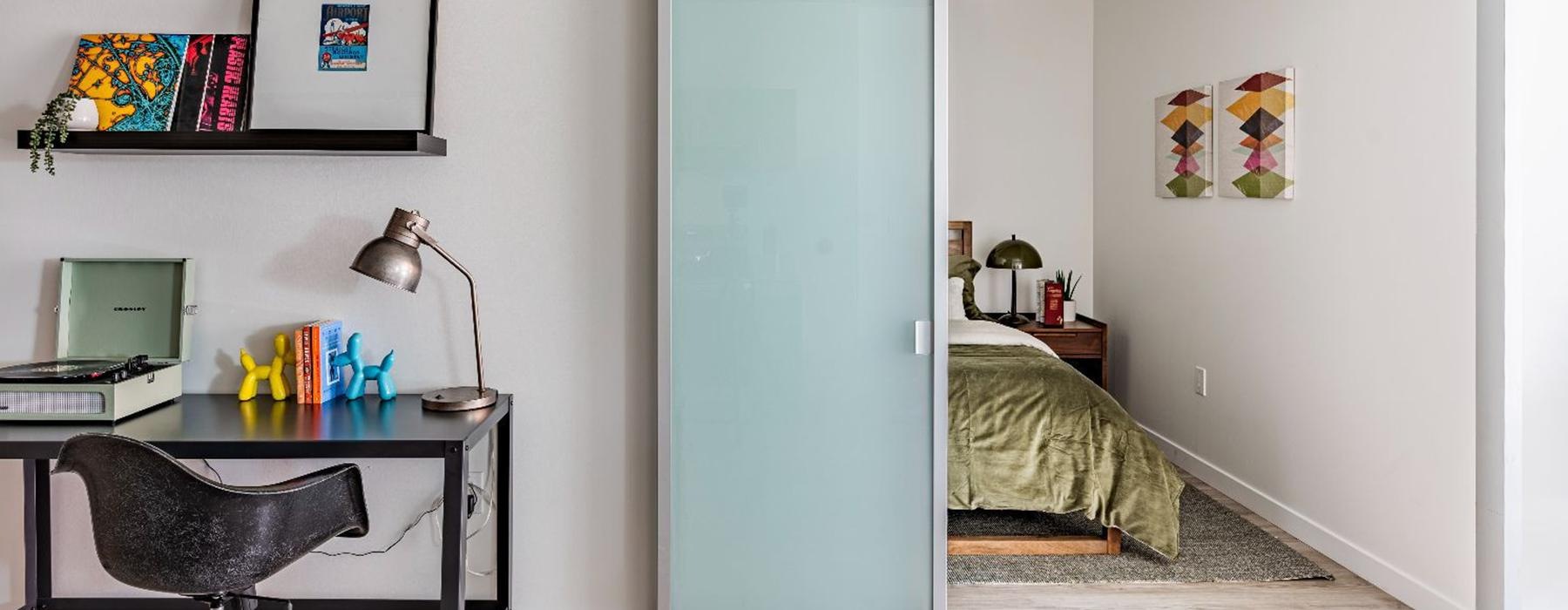 a room with a desk and a bed