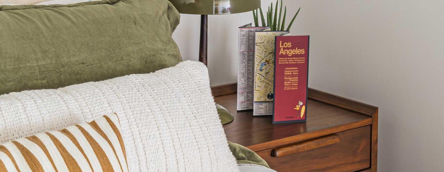 a bed with pillows and a lamp
