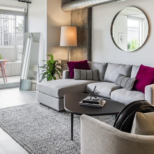 Relax and unwind in stylish living spaces a living room with a large mirror