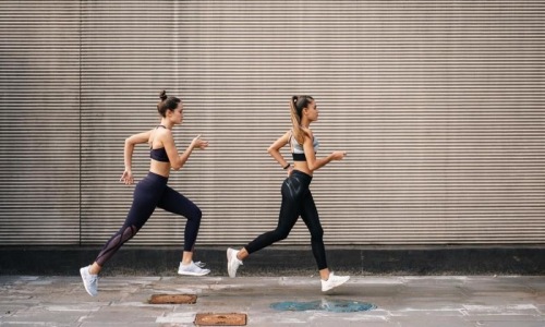 A perfect fit for the whole family two women running on a street