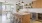a kitchen with a bar and stools